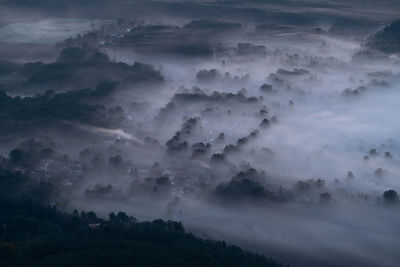 High angle view of trees and mountains against sky