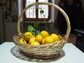 Close-up of fruits in basket on table at home