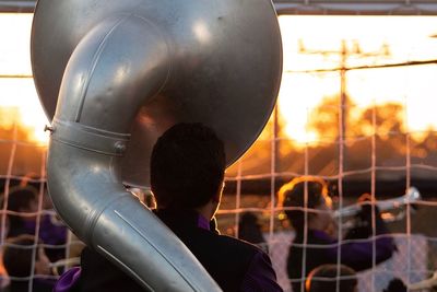 Man by trumpet during sunset