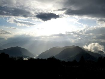 Scenic view of mountains against cloudy sky