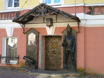 Statue outside house against building