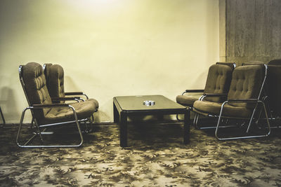 Empty armchairs by table in restaurant