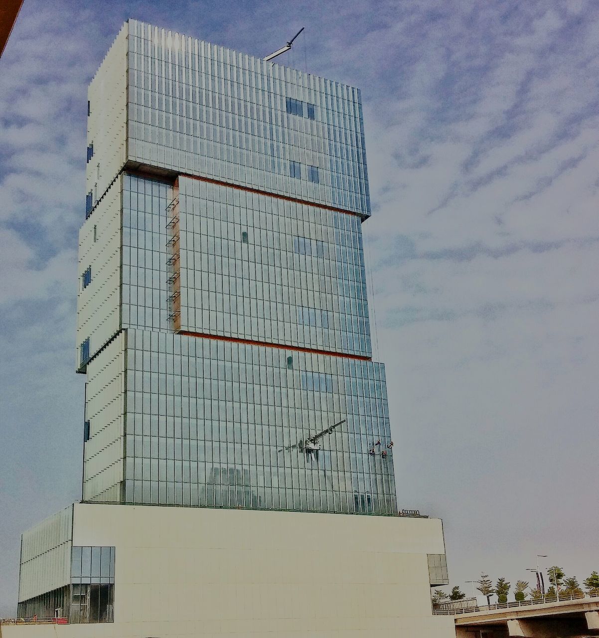 low angle view, building exterior, architecture, built structure, sky, tall - high, modern, tower, cloud - sky, building, city, development, day, skyscraper, office building, outdoors, no people, construction site, crane - construction machinery, cloud