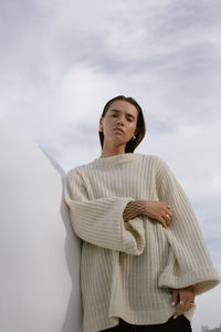 Portrait of young woman against sky