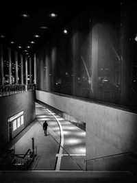 Man walking in illuminated building at night