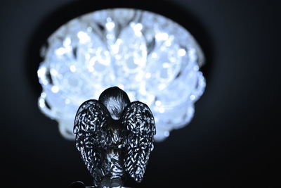 Close-up of illuminated lighting equipment against black background