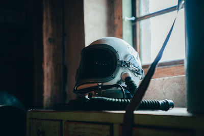 Close-up of helmet on table by window