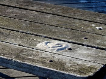 High angle view of bench on boardwalk