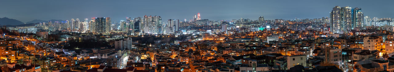 High angle view of illuminated buildings in city at night