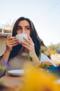 Portrait of young woman drinking coffee in cafe person