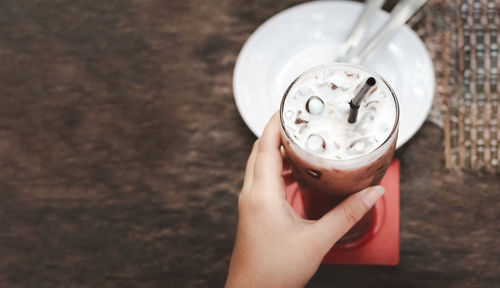 Close-up of hand holding coffee