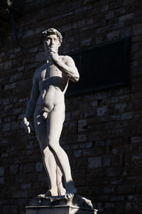 Low angle view of statue against wall