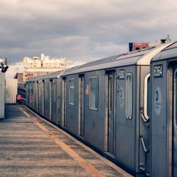 Train at railroad station against sky