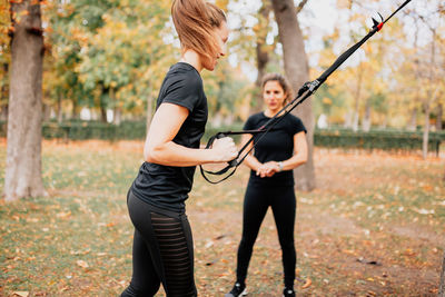 Smiling women exercising at park