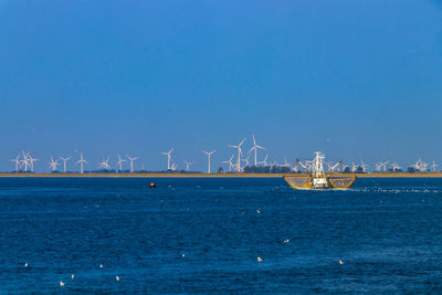 Scenic view of sea against clear blue sky