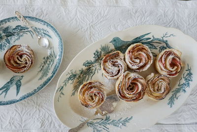 High angle view of dessert served in plates on table