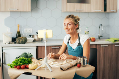 Portrait of woman preparing food at home