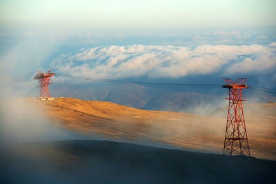 Metallic towers at bucegi natural park during foggy weather