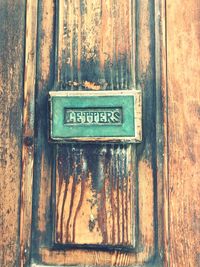 Close-up of text on old door