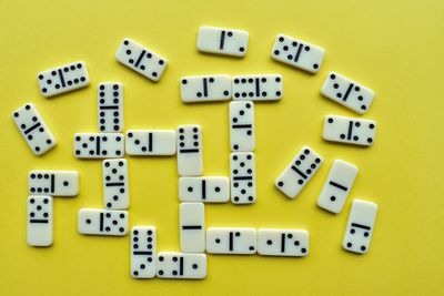 Close-up of dominoes on yellow background