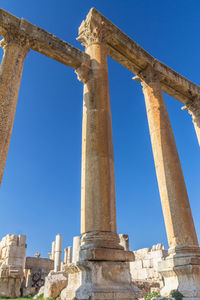 Low angle view of historical building against blue sky