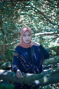 Portrait of young woman in forest