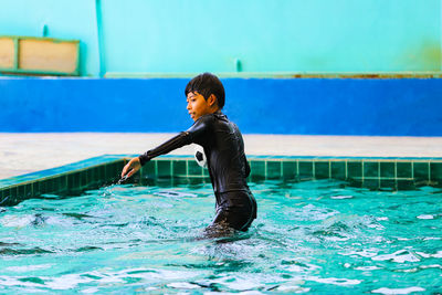 Side view of boy in swimming pool