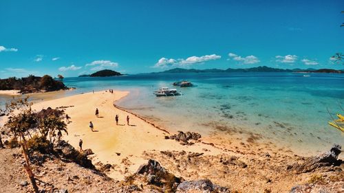 Scenic view of beach against blue sky