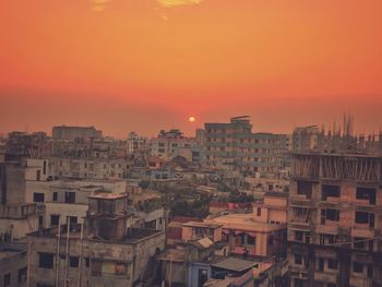 High angle view of townscape against orange sky