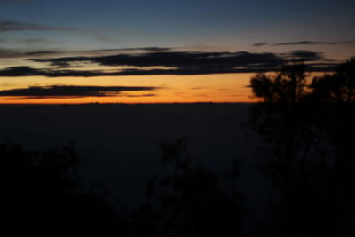Scenic view of silhouette landscape against sky at sunset
