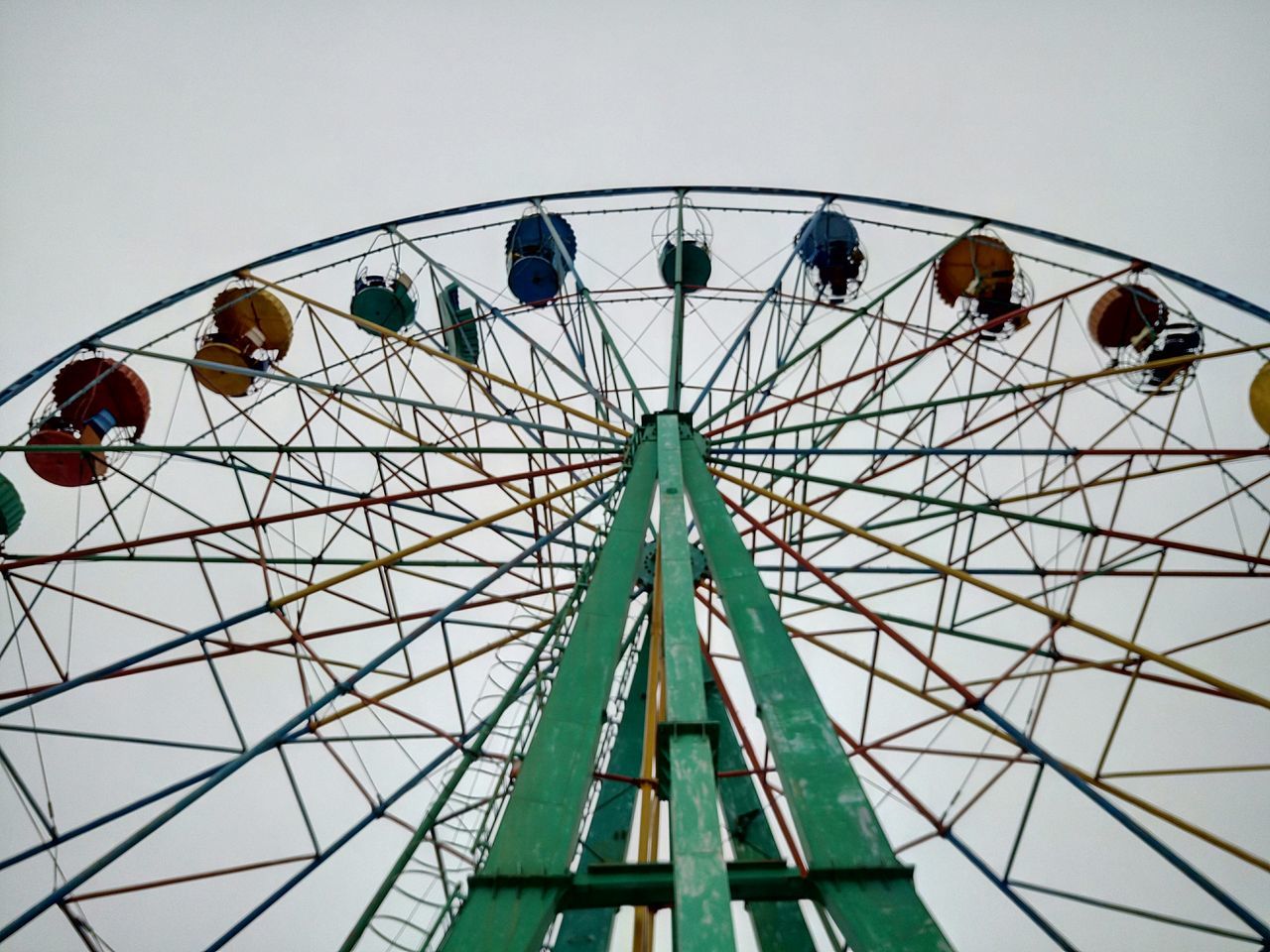 amusement park ride, amusement park, low angle view, ferris wheel, arts culture and entertainment, built structure, clear sky, architecture, sky, fun, leisure activity, enjoyment, travel destinations, day, traveling carnival, chain swing ride, fairground ride, outdoors, famous place, metal