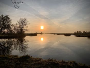 Scenic view of lake against sky during sunset