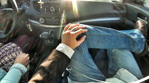 Midsection of man sitting in car