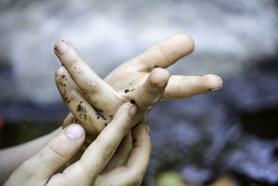 Cropped image of dirty hands outdoors
