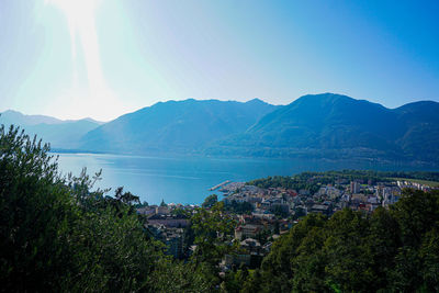 High angle view of townscape by bay against sky