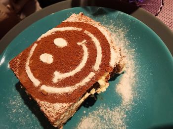 High angle view of anthropomorphic face made on dessert in plate