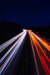 High angle view of light trails on highway at night