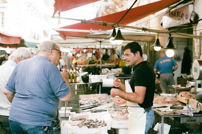 People working at market stall