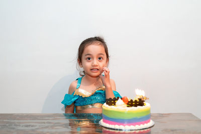 Little girl celebrating her birthday at home during quarantine. wearing arabian princess costume.