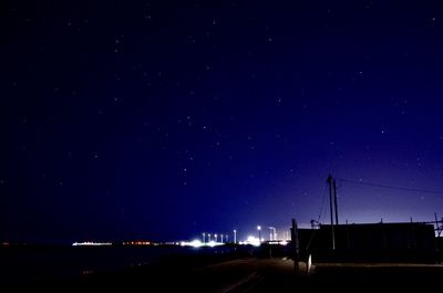 Illuminated city against sky at night