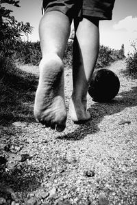 Low section of man walking on street