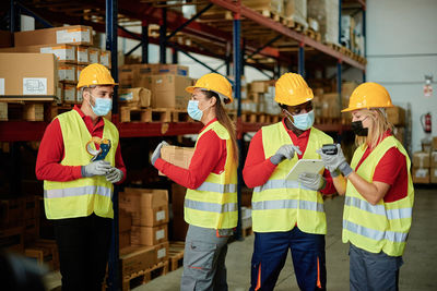 Rear view of people standing in factory