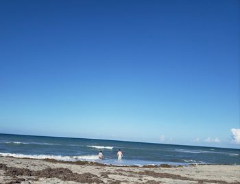 Scenic view of sea against clear blue sky