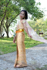 Girl in traditional clothing standing at park