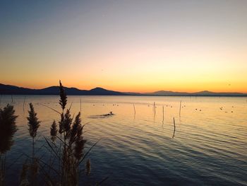 Scenic view of lake against sky during sunset