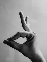 Close-up of human hand against white background