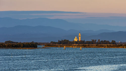 Sunset on the grado marano lagoon and a glimpse of the island of barbana.