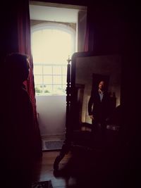 Young woman sitting in room