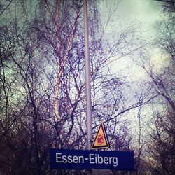 Low angle view of road sign against sky