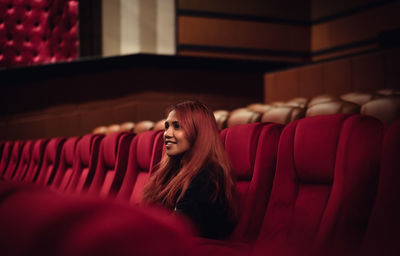 Smiling woman sitting in movie theater